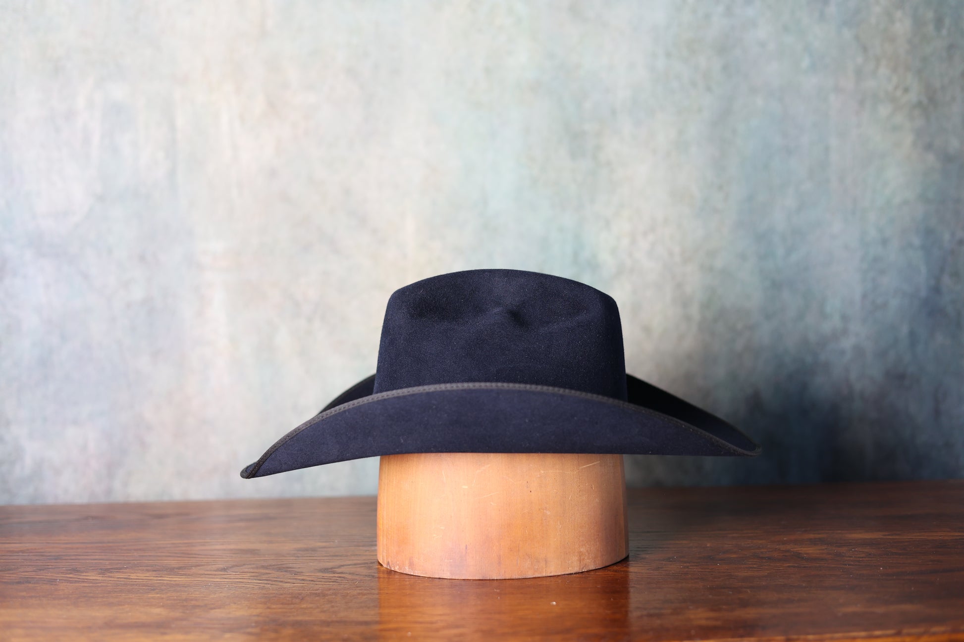 Zoomed out side photo of the Friday the 13th “The River Rat” Limited Edition Cowboy Hat from Greeley Hat Works with Bayou Blue felt on a plain grey background