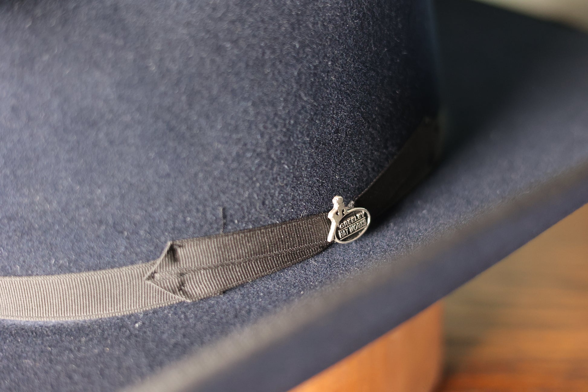 Photo of the greeley hat works emblem on the band of the Friday the 13th “The River Rat” Limited Edition Cowboy Hat from Greeley Hat Works with Bayou Blue felt and black band