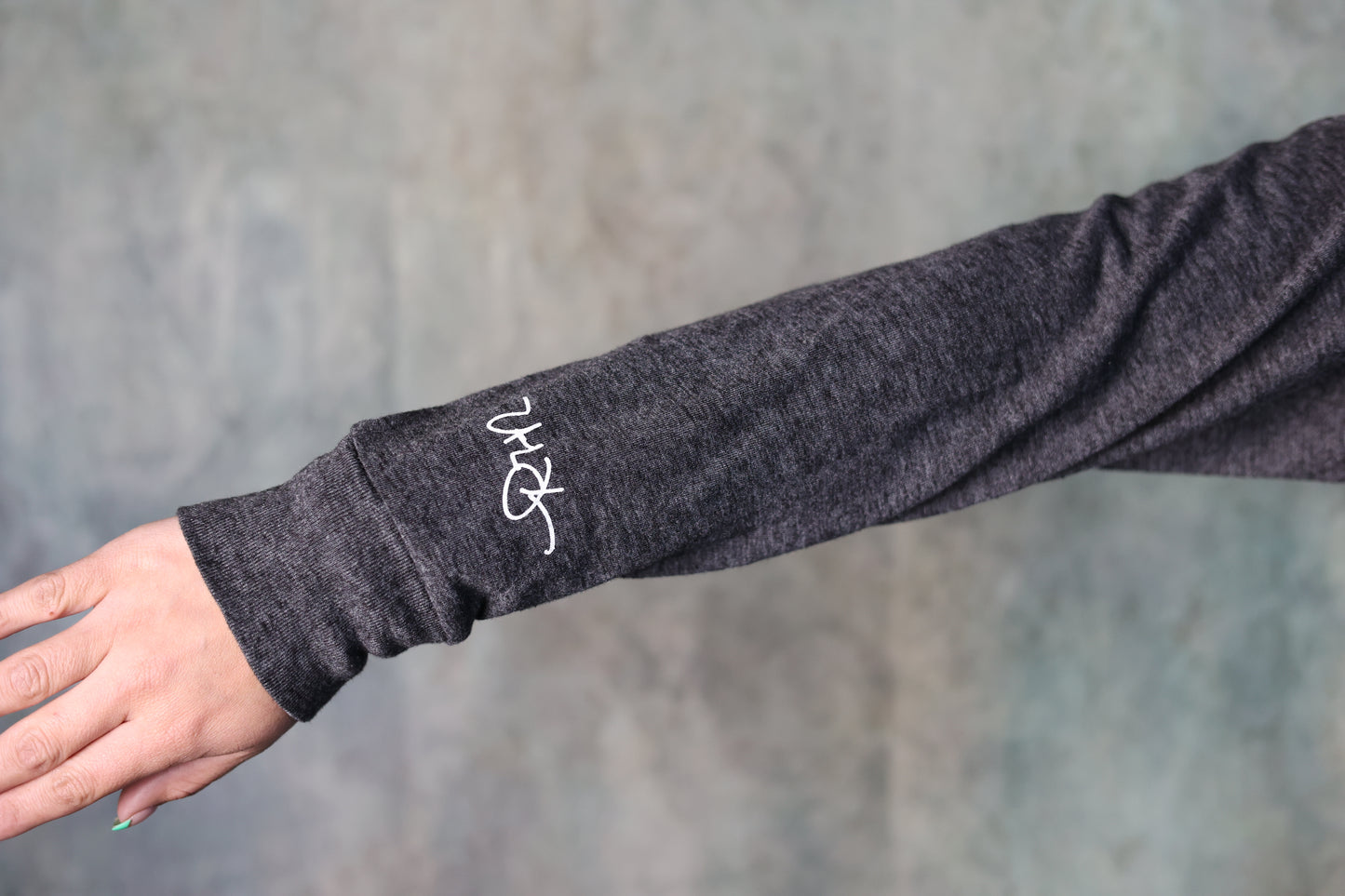 Close-up photo of the sleeve design of the Still Western Zip-up Hoodie from Greeley Hat Works