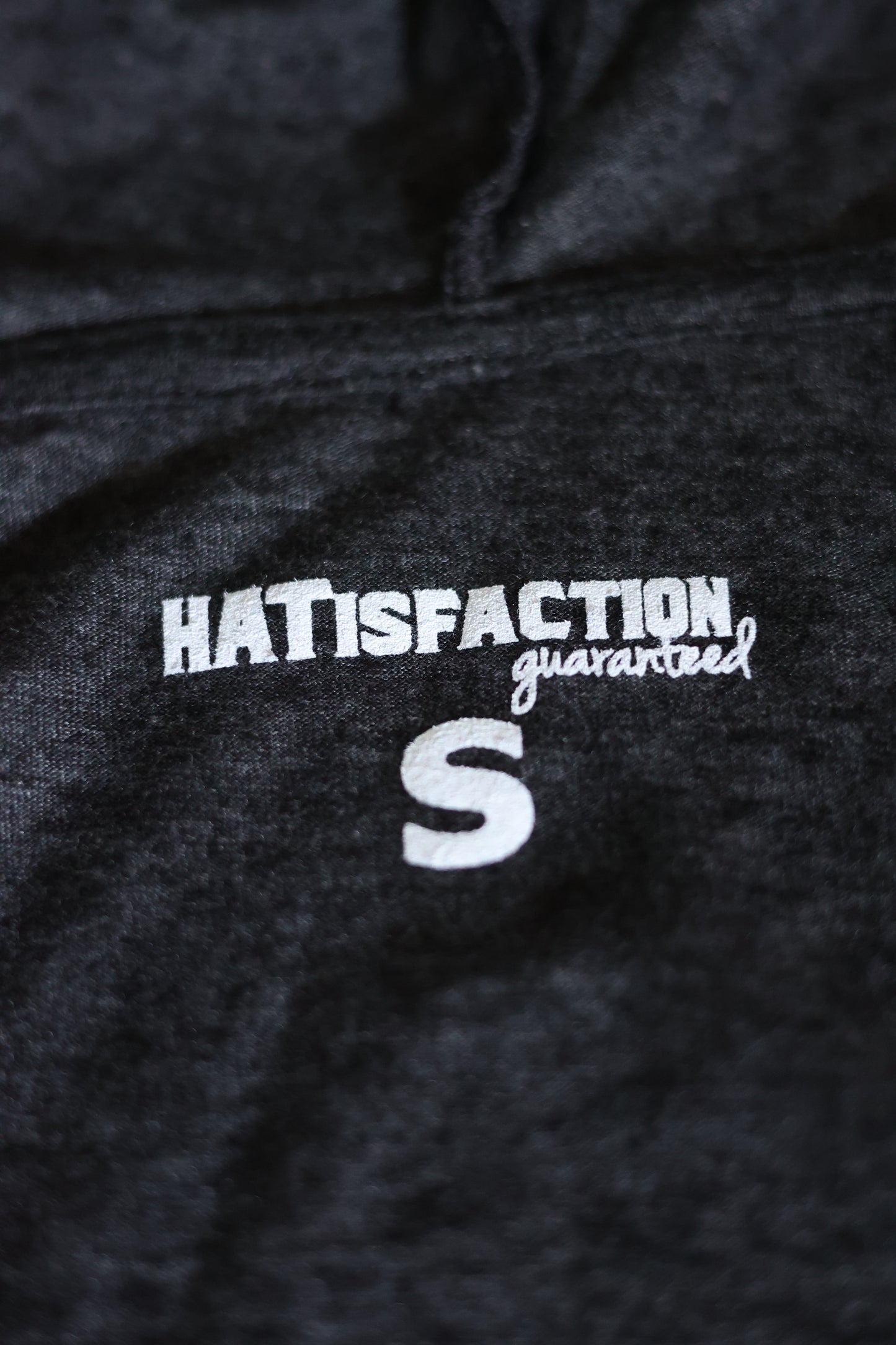 Photo of the HATisfaction Guaranteed embroidering on the Still Western Zip-up Hoodie from Greeley Hat Works