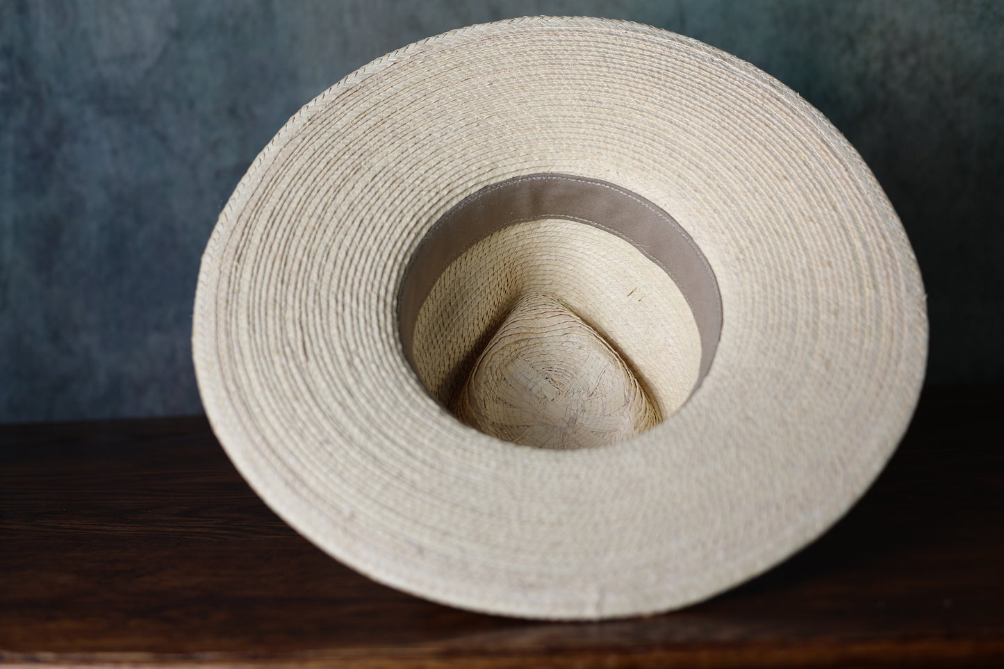 Photo of the underside of a SunBody Casa Blanca Palm Leaf straw hat with black band from Greeley Hat Works