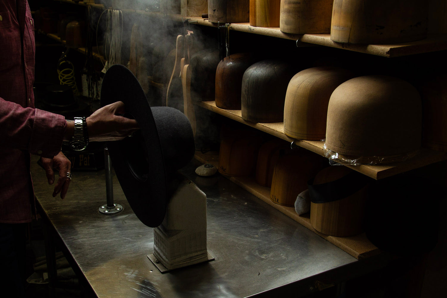 Greeley Hat Works owner Trent Johnson shapes a black hat.