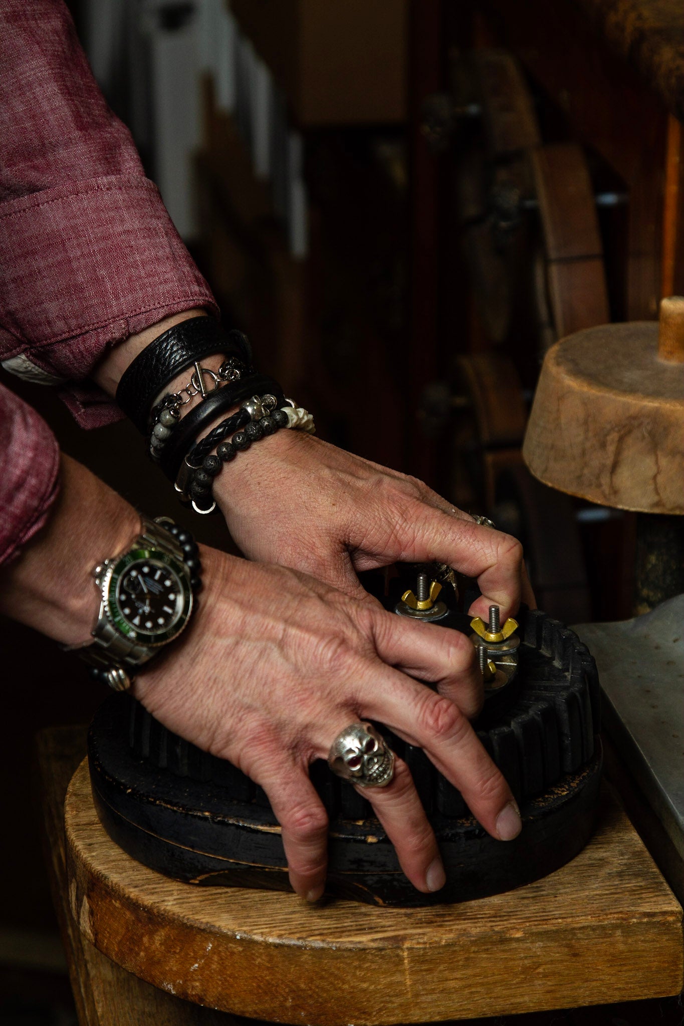 Photo of hatmaker at Greeley Hat Works in Greeley, Colorado setting up the tools to make a custom western hat for a customer