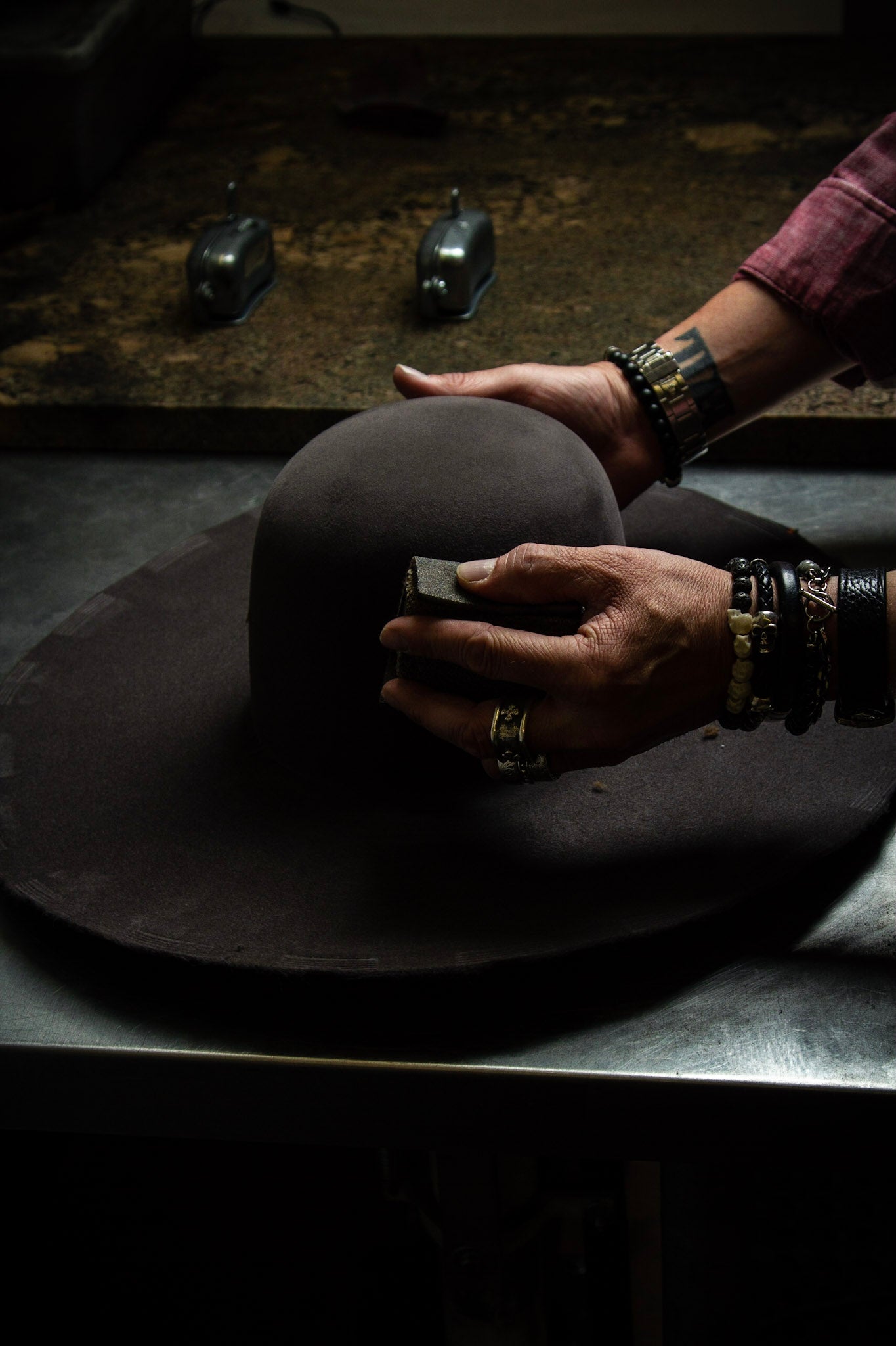 Photo of hatmaker at Greeley Hat Works in Greeley, Colorado shaping a custom cowboy hat