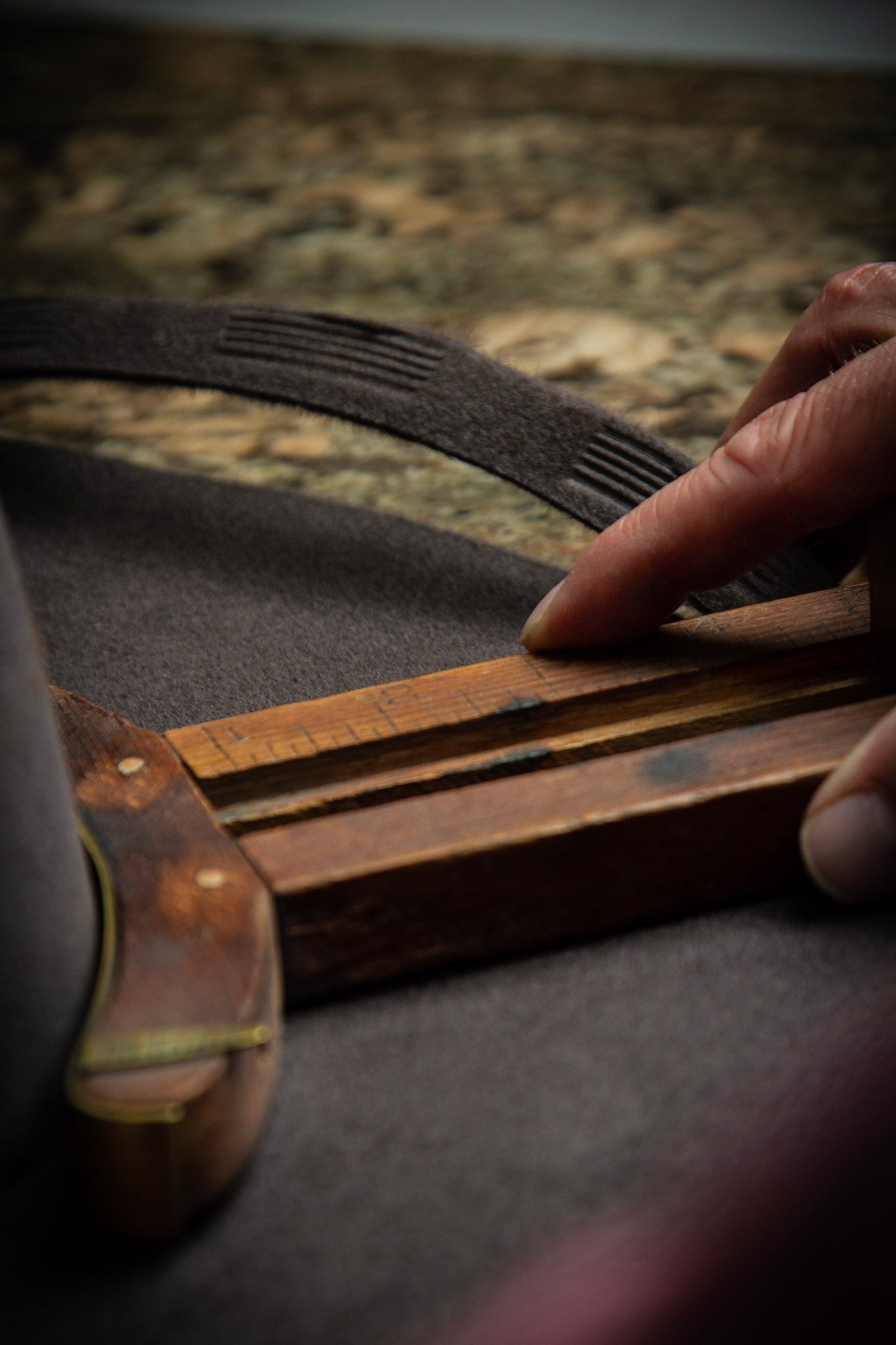 Photo of hatmaker at Greeley Hat Works in Greeley, Colorado using a sizer to make a custom western hat for a customer
