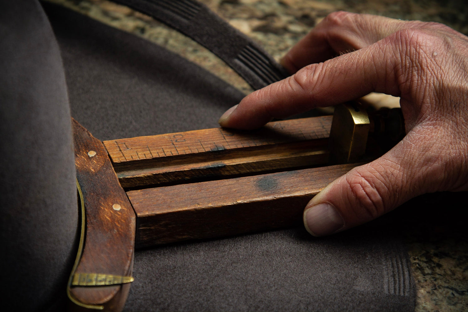 Greeley Hat Works owner Trent Johnson trims the brim of a custom hat.