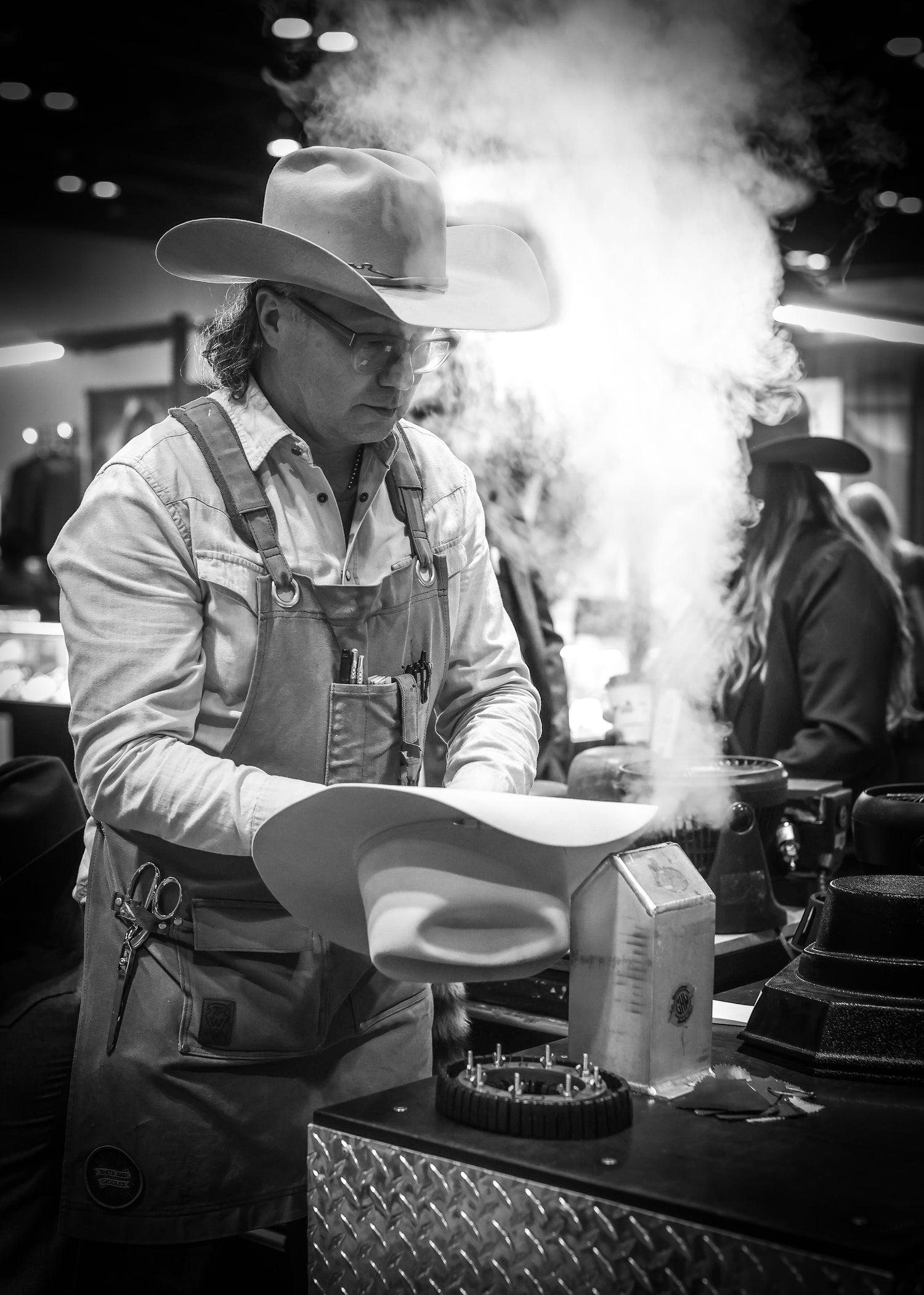 Greeley Hat Works owner Trent Johnson shapes hats to customize the look of hats to fit each individual's preferences.