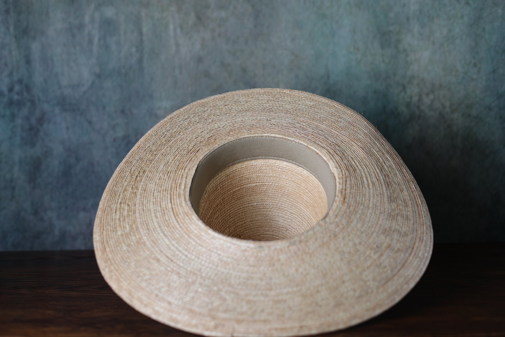 Underside of a beige straw hat (Sunbody Oak Open Crown Palm Hat 5" Brim) from Greeley Hat Works
