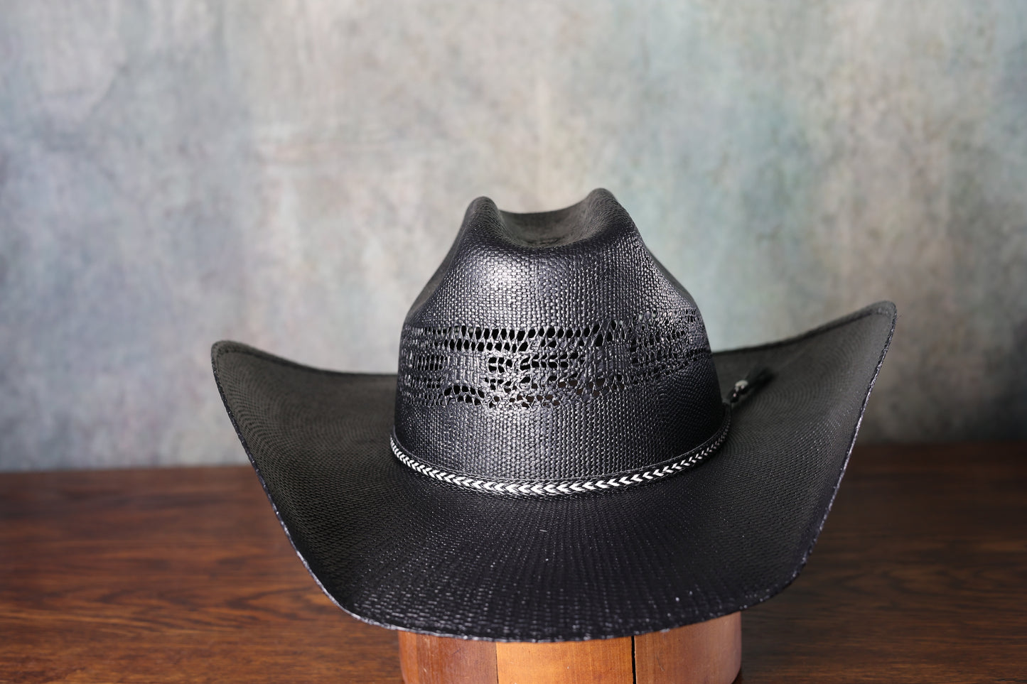 Photo of Black Bangora Pre-Shape 4 1/2” Brim cowboy hat on a wooden block with a textured gray background