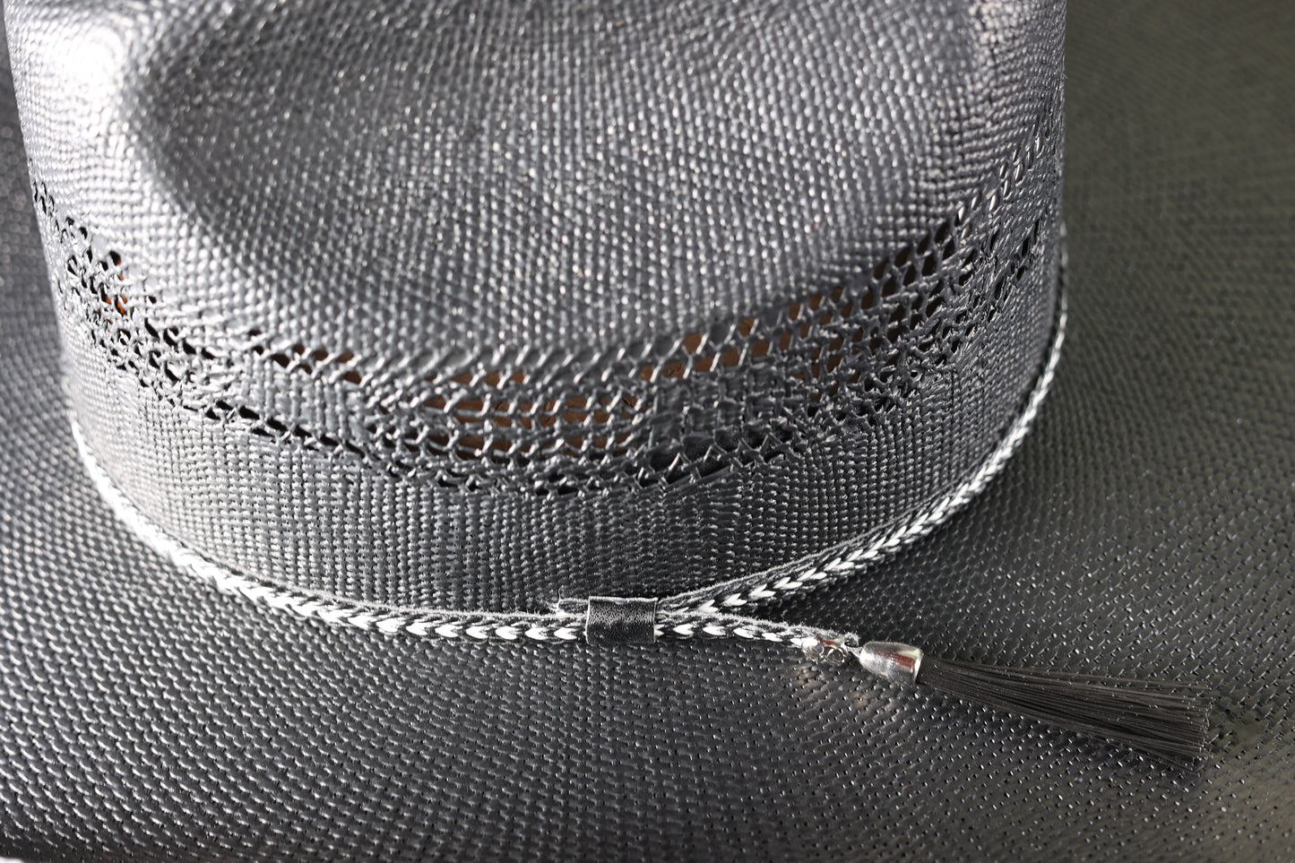 Detailed photo of the design and band on the Black Bangora Pre-Shape 4 1/2” Brim cowboy hat from Greeley Hat Works on a wooden block with a textured gray background