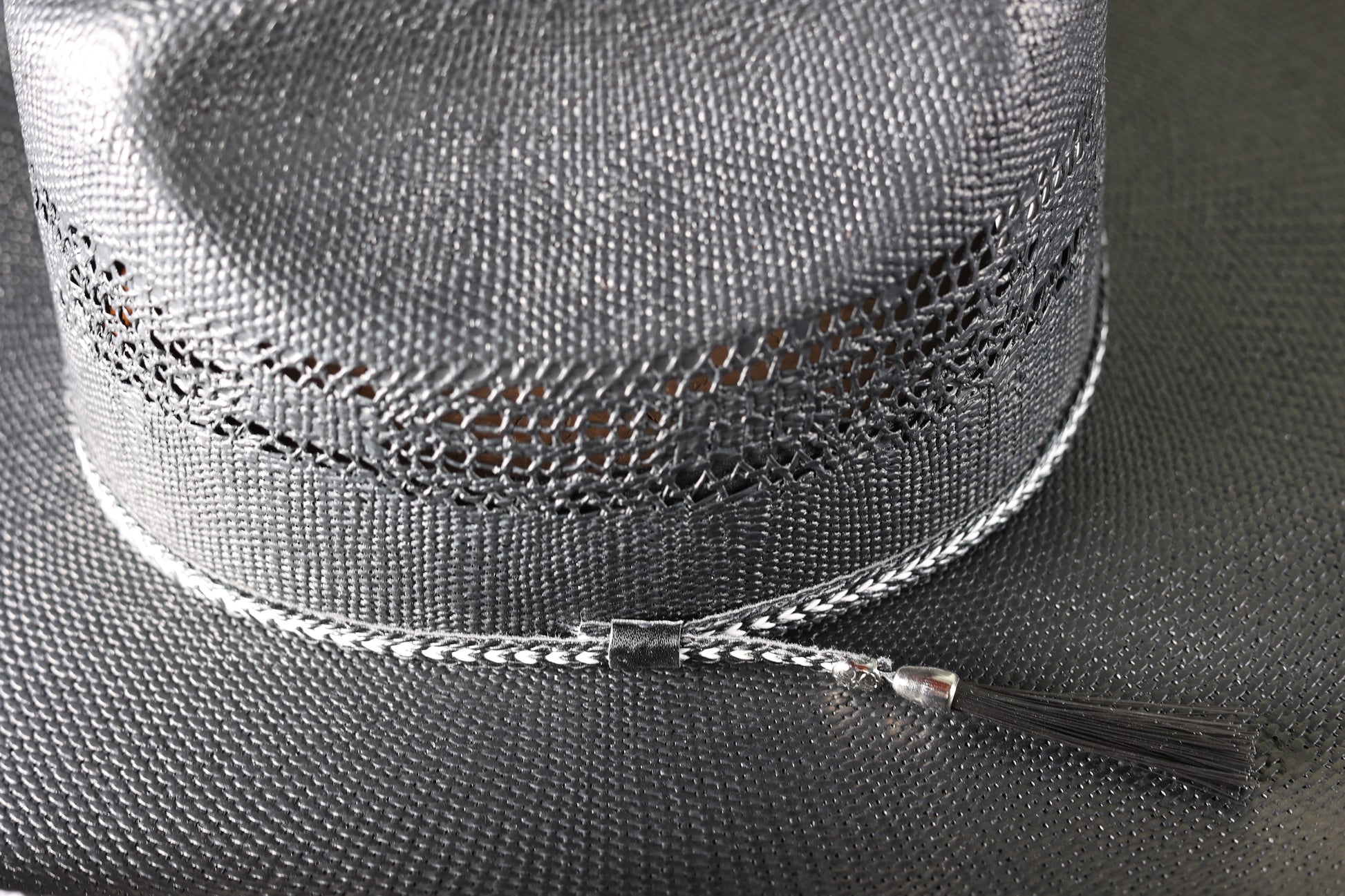Detailed photo of the design and band on the Black Bangora Pre-Shape 4 1/2” Brim cowboy hat from Greeley Hat Works on a wooden block with a textured gray background