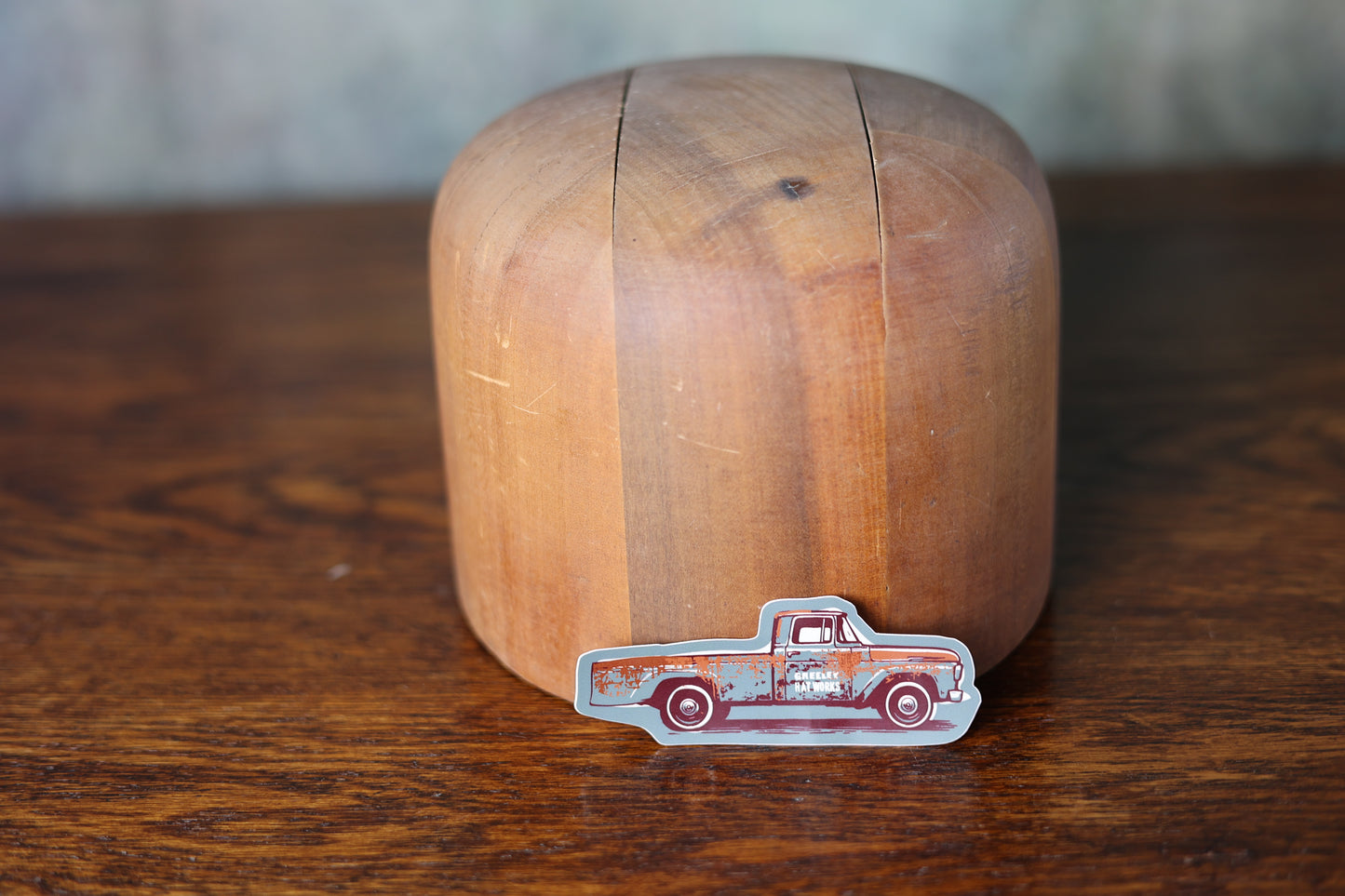 Photo of a greeley hat works antique truck sticker leaning on a hat mold