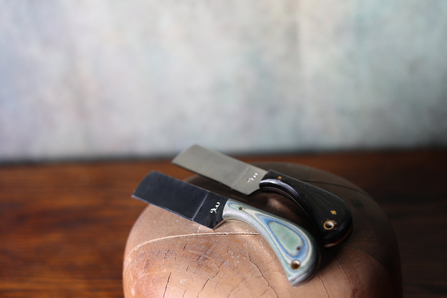 Two 9 Lazy 3 Knives on a wooden surface with a blurred background