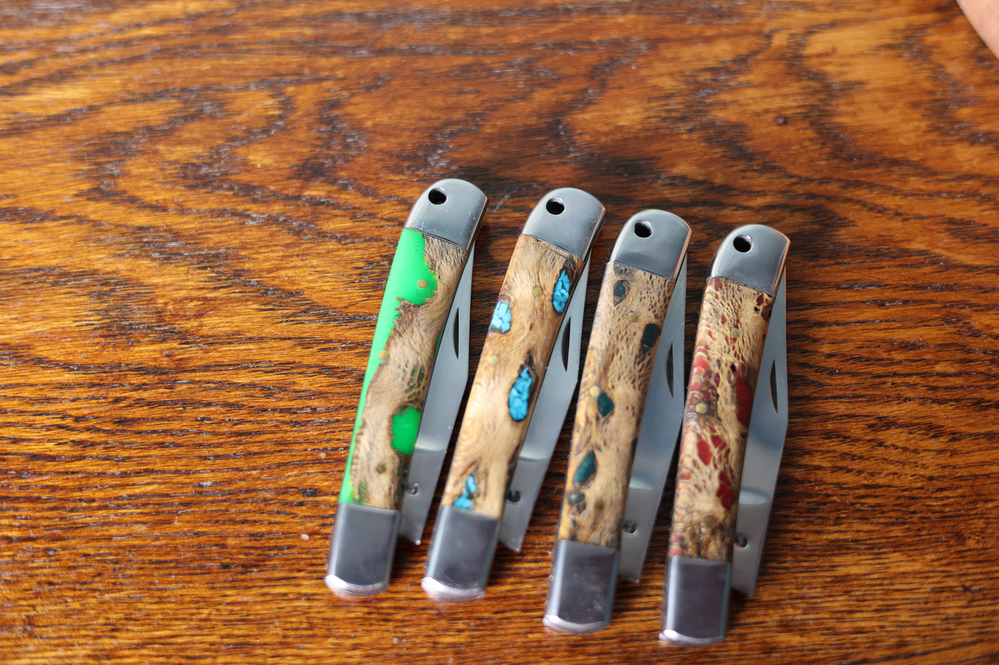 Photo showing the unique handles of four 9 Lazy 3 Knives from Greeley Hat Works