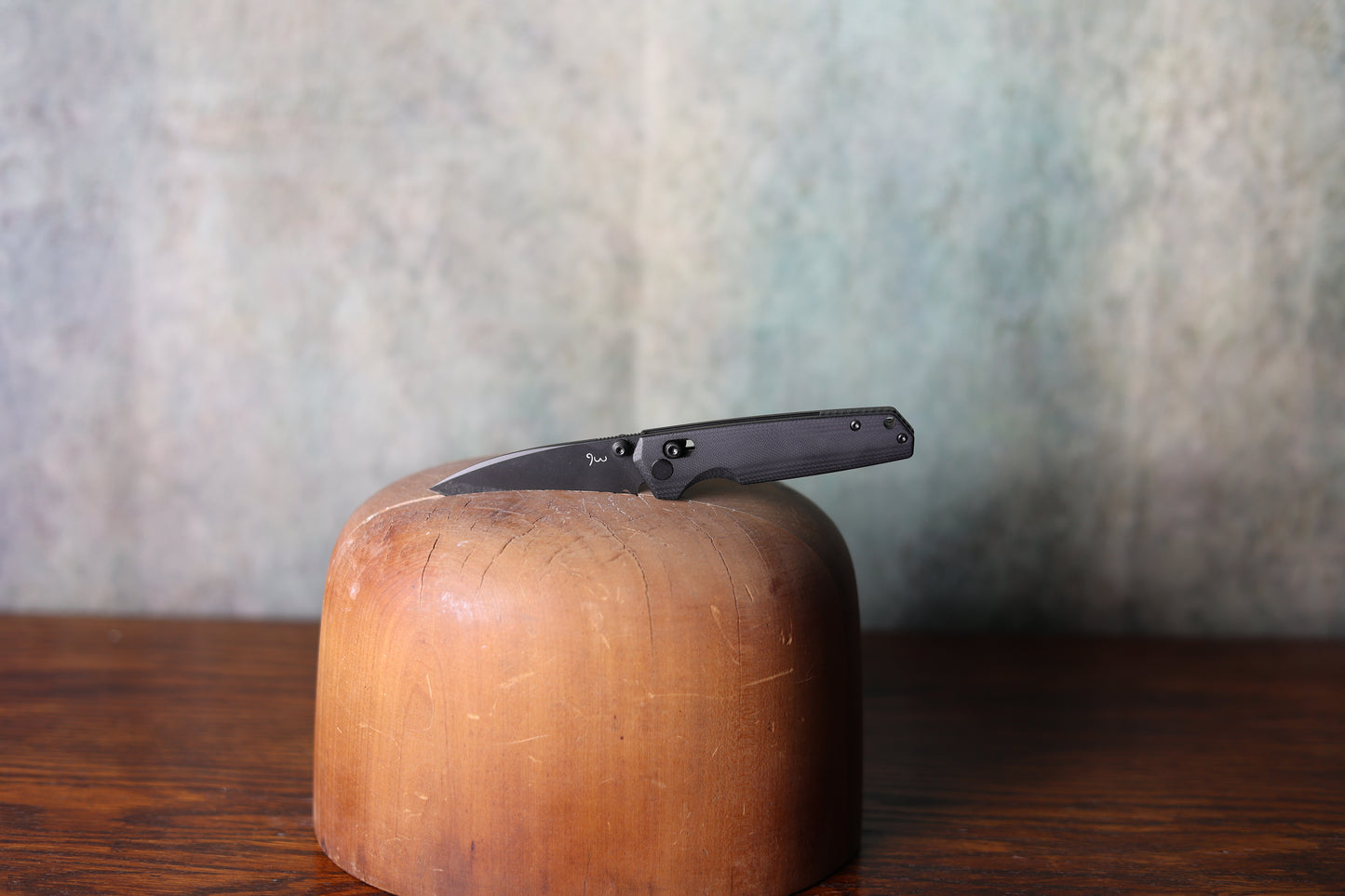A gunmetal grey 9 Lazy 3 Knives from Greeley Hat Works on a wooden hat mold