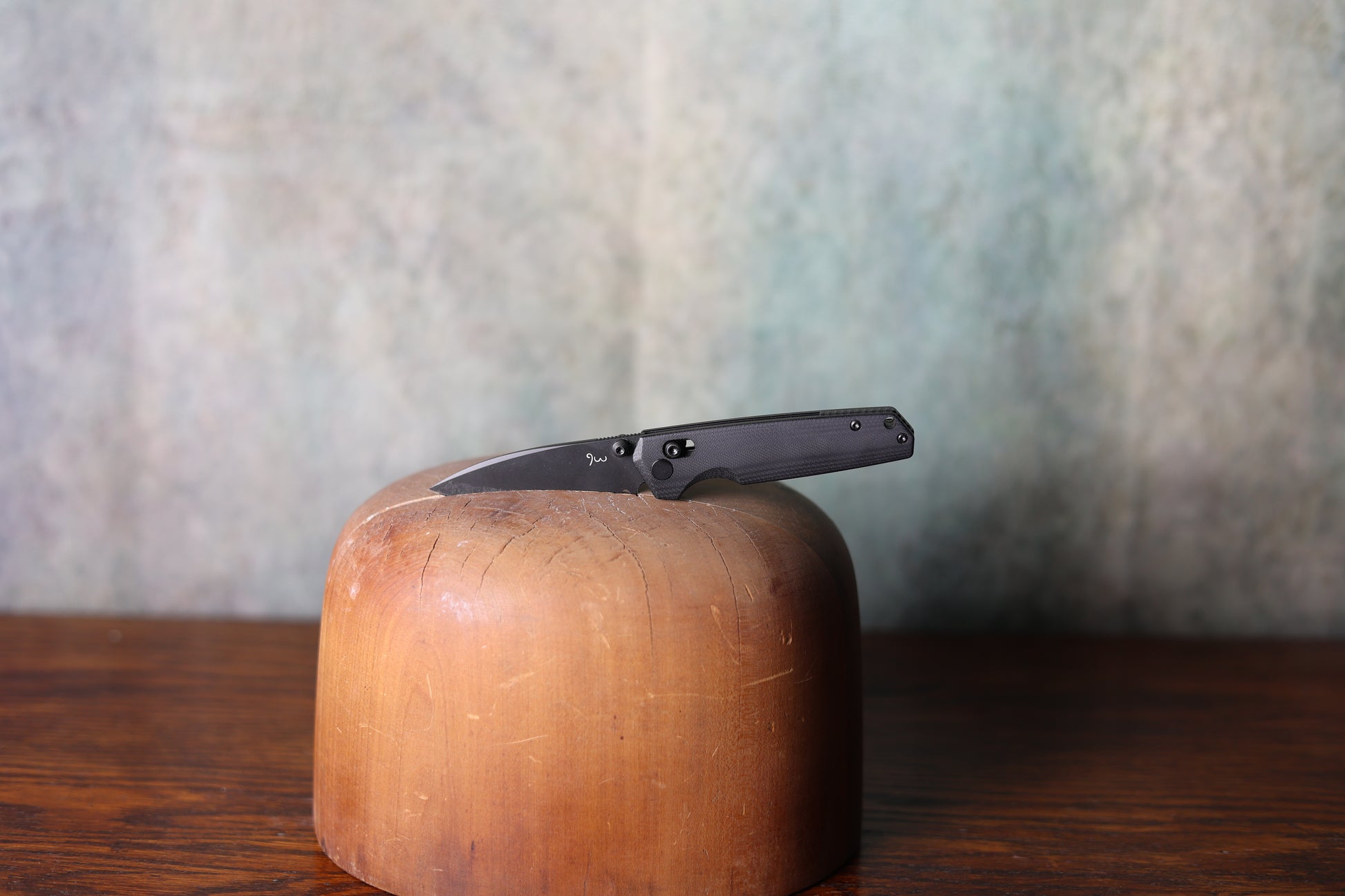 A gunmetal grey 9 Lazy 3 Knives from Greeley Hat Works on a wooden hat mold