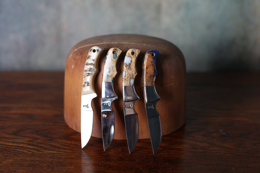 Photo of four 9 Lazy 3 Knives leaning upon a wooden hat mold