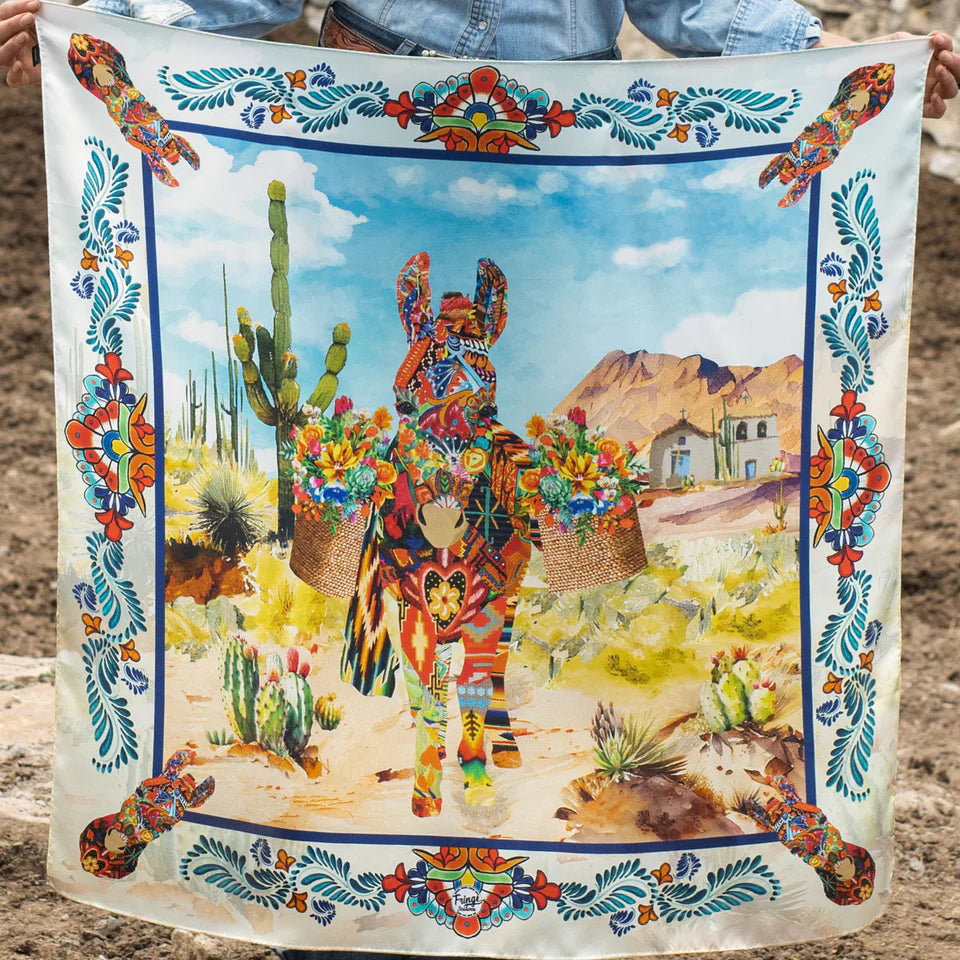 Colorful Fringe Scarves Wild Rag from Greeley Hat Works with a donkey and desert scene design held by a person.