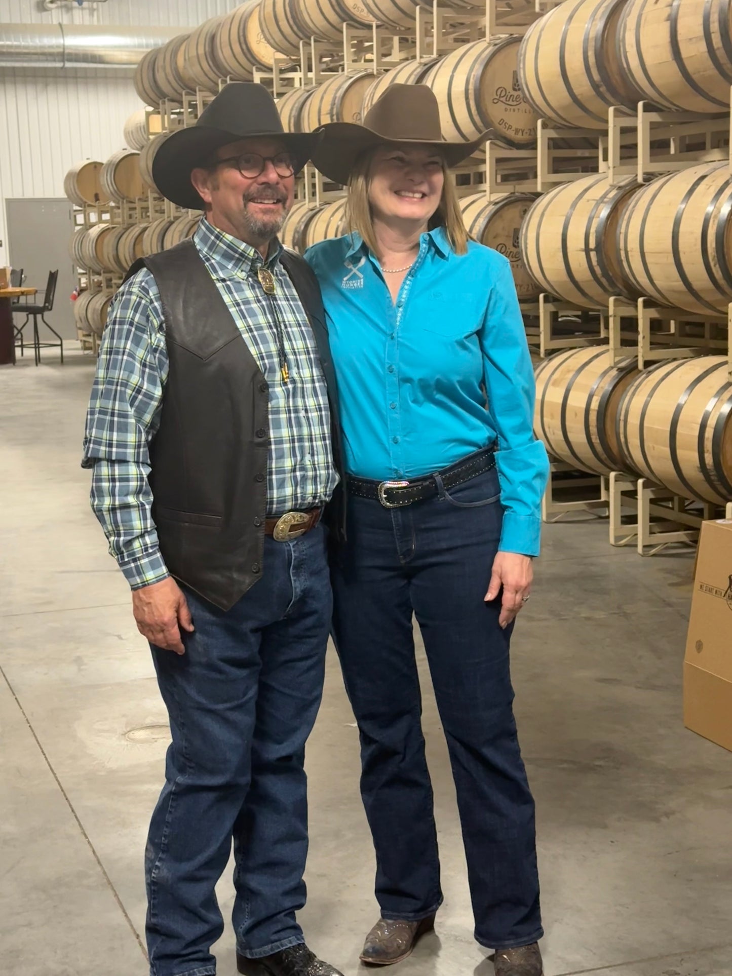 CJ and First Lady of Wyoming Jennie Gordon in a barrel house at Pine Bluffs Distilling