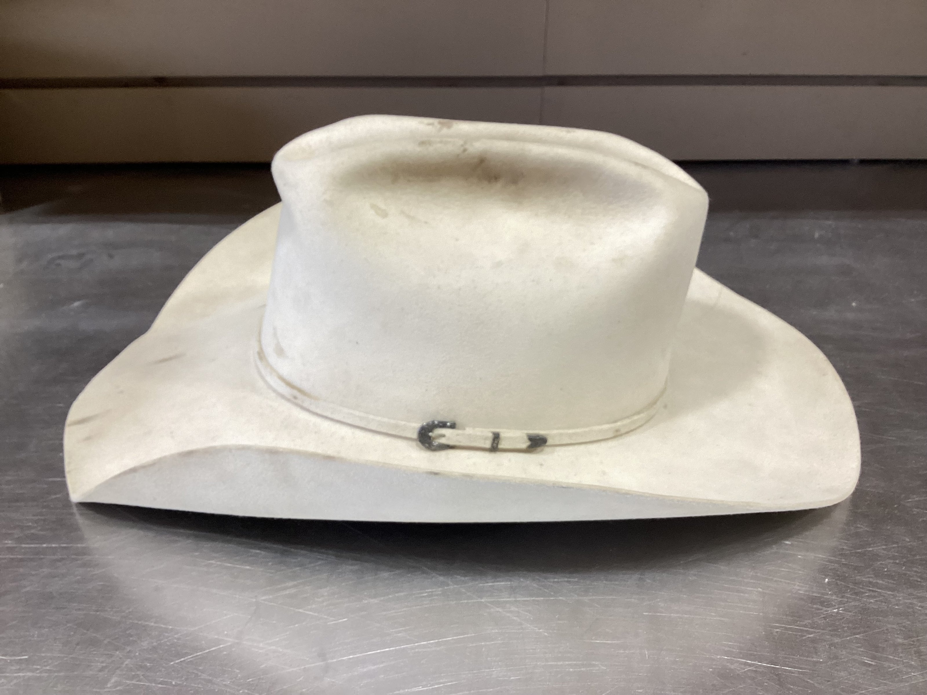 Side photo of cream-colored cowboy hat prior to ReCraft services from Greeley Hat Works